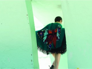 <p>3gg hand flat machine intarsia cape, with hand knotted wool fringes.</p>
